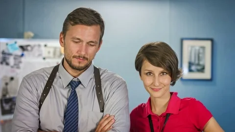 Two attractive detective posing in their workplace in the police office Video stock 70571326