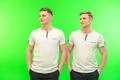 The two attractive twin stand on the green background Photo