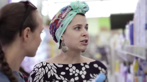 Two attractive womans choosing body care products In supermarket. Stock Footage 74078221