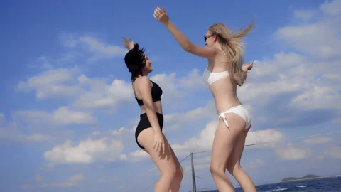 Two attractive women in bikini dancing summer holiday party in cruise Video stock 171754731