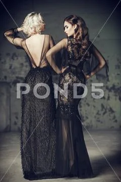 Two attractive women in evening dresses, Elegant fashion. Stock Photos