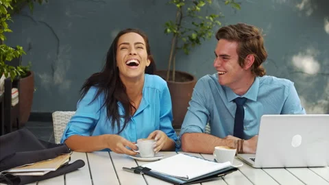 Two attractive young and exited professionals, brainstorming there ideas with a Stockbeeldmateriaal 199634462