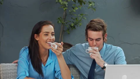 Two attractive young and exited professionals, brainstorming there ideas with a Video stock 199634483