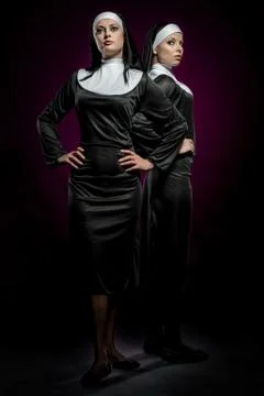 Two attractive young nuns posing indoors Stock Photos