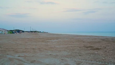 Two ATVs ride along the sandy beach Stock Footage 94498889