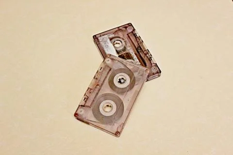 Two audio cassettes located on a white background Stock Photos