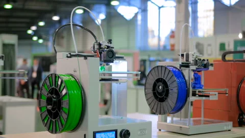 Two automatic three dimensional 3D printer working at technology exhibition Video stock 103412993