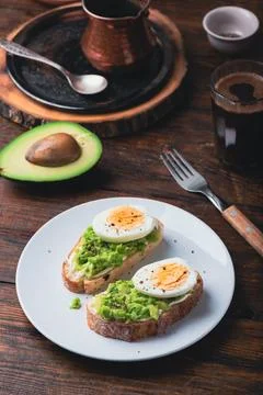 Two avocado toasts with boiled egg Stock Photos