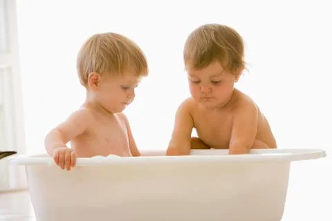 Two babies in bubble bath Stock Photos