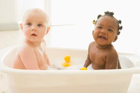 Two babies in bubble bath Stock Photos