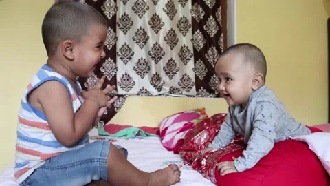Two babies playing with each other little baby clapping. Stock Footage 148077934