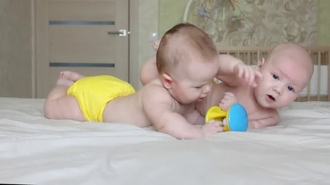Two babies playing Stock Footage 79887527