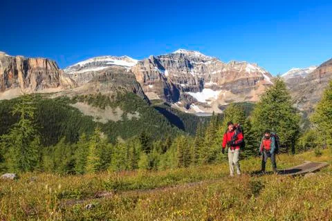 Two back packers ascend the trail from Egypt Lake in Banff National Park, Stock Photos