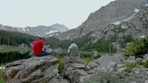 Two Backpackers eating at Pear Lake Stock Footage 147932691