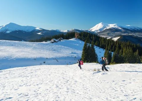 Two backpackers in snowy mountains Stock Photos