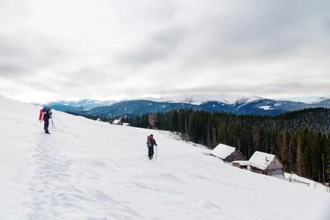 Two backpackers in snowy mountains Stock Photos