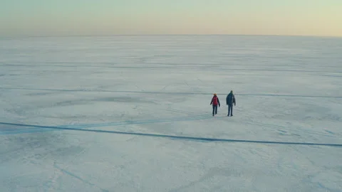 The two backpackers trekking through the icy snow field Stock Footage 189346254