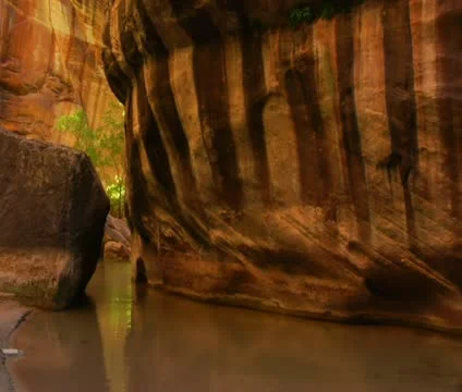 Two backpackers wade through water in canyon Stock Footage 21683826