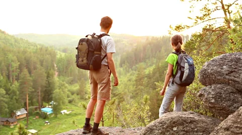 Two backpackers walk and looking at sunset Stock Footage 39861578