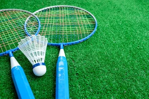 Two badminton mini rackets with white shuttlecock on the green background, ac Stock Photos
