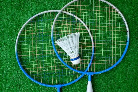 Two badminton mini rackets with white shuttlecock on the green background, ac Stock Photos