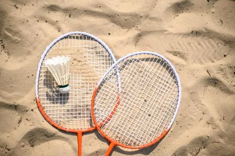 Two badminton rackets on the beach Stock Photos