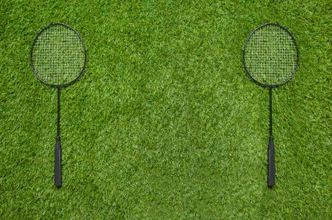 Two badminton rackets lying on the grass Stock Photos