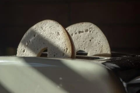 Two bagel halfs in a toaster Stock Photos