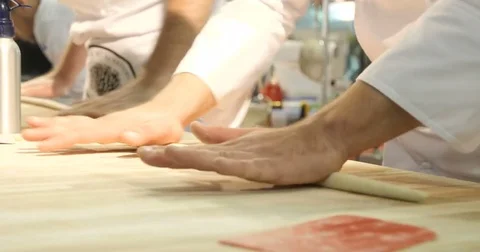 Two Bakers kneading dough on table Video stock 82699679