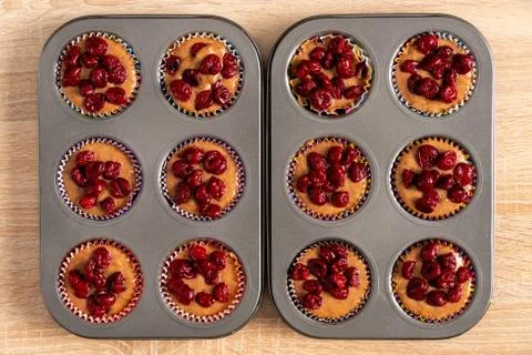 Two baking trays with raw cake mixture and cherries Stock Photos