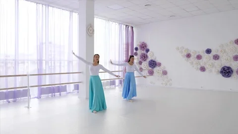 Two ballerinas is rehearsing a dancing elements together. Stock Footage 122032867
