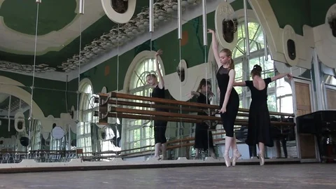 Two ballerins dance on pointe in the ballet hall Stock Footage 76649839