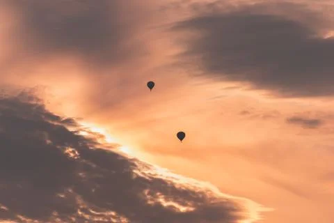 Two balloons on a background of pink sunset and clouds Stock Photos