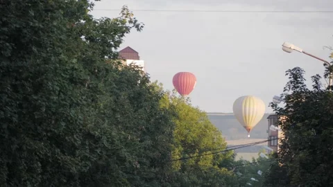 Two balloons fly in distance on background city. Russia, Stavropol - 29.08.20 Stock Footage 144246697