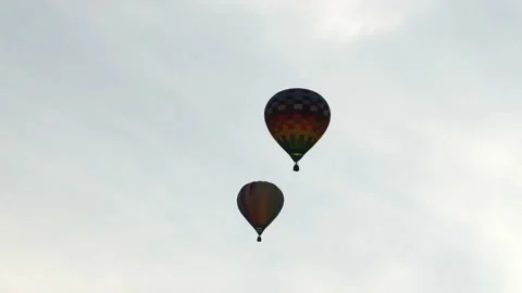 Two balloons fly side by side. Colorful balloons. Balloons on the sky background Stock Footage 150101924