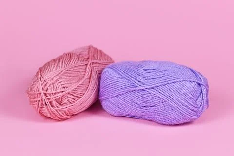 Two balls of wool on pink background Stock Illustration
