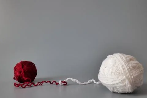 Two Balls of Yarn Connected by Threads Stock Photos