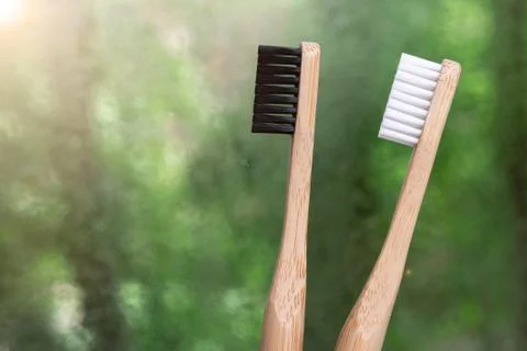 Two bamboo toothbrushes close-up on a background of nature. Foto stock