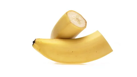 Two banana halves rotating. Isolated on white background. Stock Footage 166231897