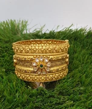 Two Bangles Or Kadas Or Kangan places on a surface being focused Stock Photos