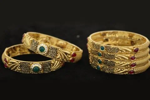 Two Bangles Or Kadas Or Kangan places on a surface being focused Stock Photos
