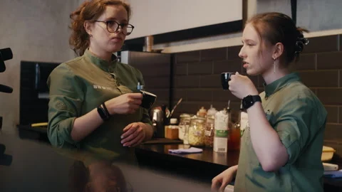 Two baristas taking a coffee break 库存影片 313334545