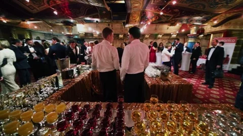 Two bartenders are in bar with many wine glasses during Award Records of real Stock Footage 276371937