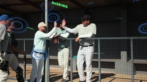 Two baseball players leaning on railing, player reaching across starting Video stock 334370008