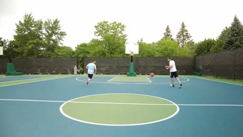 Two basketball players dribbling down the court Stock Footage 161494635