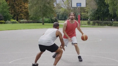 Two basketball players playing one on one outdoors Video stock 79604455