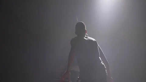 Two basketball players shadow playing one on one indoors in room with smoke and Stock Footage 93448764