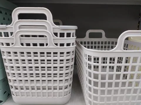 Two baskets on white shelf Stock Photos