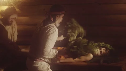 Two Bath Attendants Are Making Massage With Oak Brooms To A Boy In Sauna Stock Footage 146599299