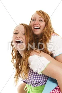 Two bavarian dressed girls having fun Stock Photos